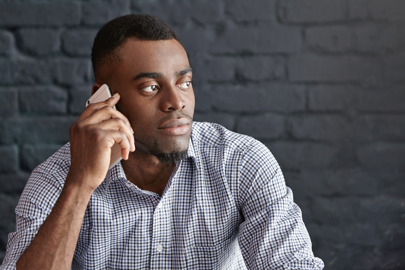 A Black consumer on the phone, representing connection, access, and consumer decision-making.